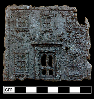 The front of a cast iron toy bank. 8cm x 8cm. See example on right from private collection. The top and bottom parts were screwed into place (N/A 2017). Height: 5.75&rdquo;, from 18BC27.